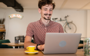 Man smiling while working on computer