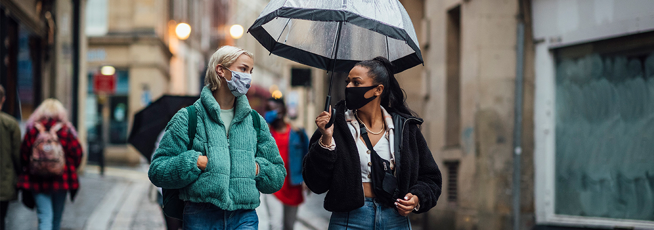 Two women talking with masks
