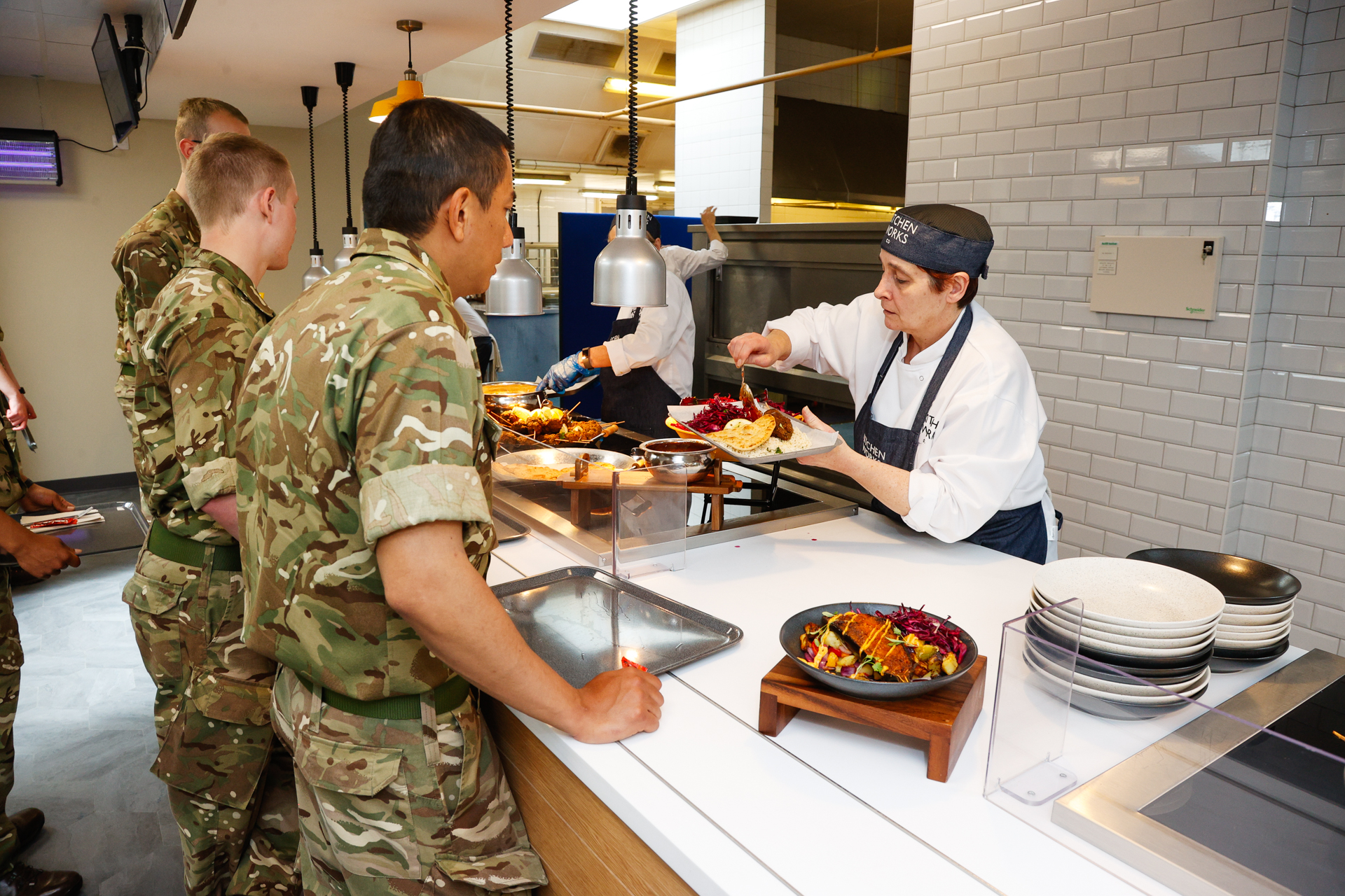 military personnel being served with food