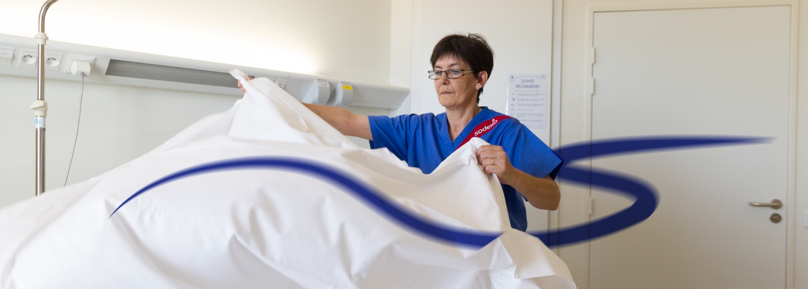 Hospital employee cleaning hospital bed