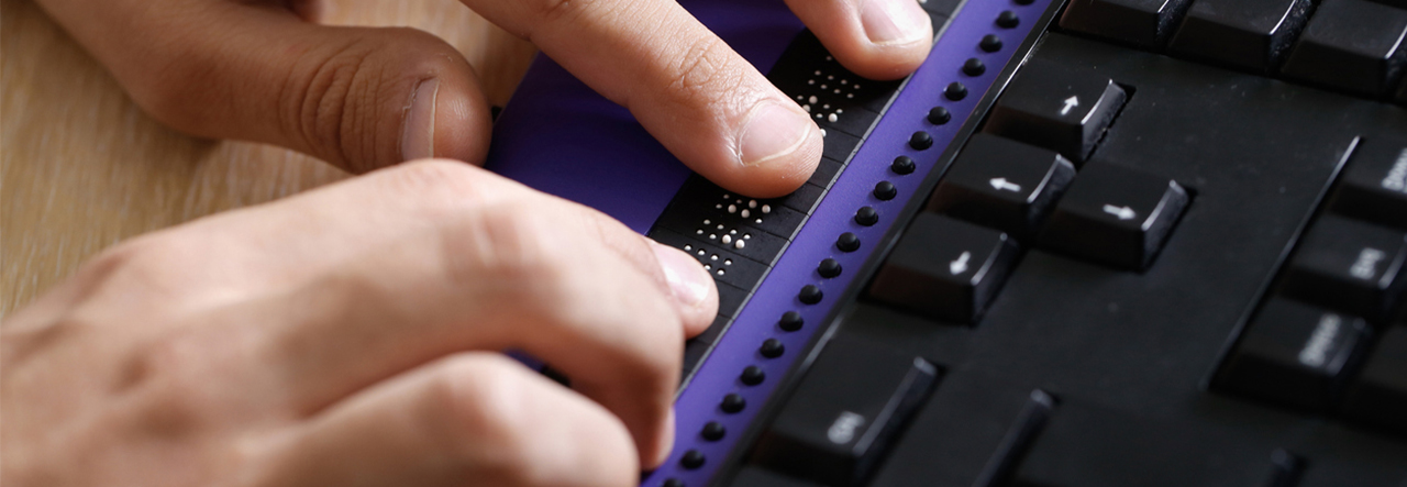 Hands typing on an accessible keyboard